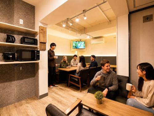 a group of people sitting in a waiting room at Akasaka Guesthouse HIVE in Tokyo