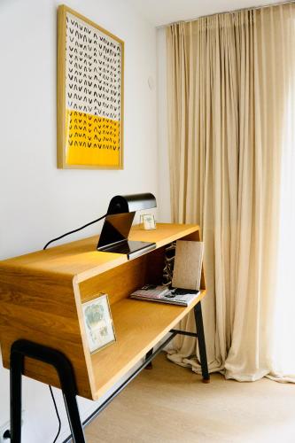 a desk with a laptop computer on top of it at Boutique Home Bad Iburg in Bad Iburg