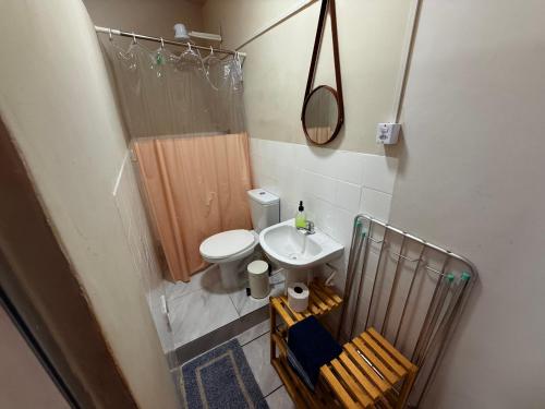 a small bathroom with a toilet and a sink at Pousada Vilas do Frances Beira Mar in Praia do Frances