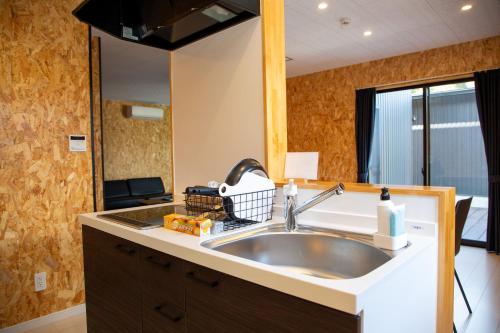 a bathroom with a sink and a mirror at Win Village in Sasebo