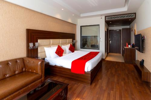 a hotel room with a bed and a couch at The Grand Ambassador in Phagwāra