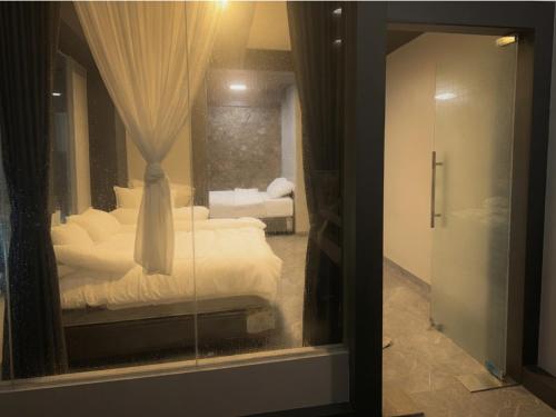 a bedroom with a reflection of a bed in a mirror at Teupin Layeu Hotel in Iboih