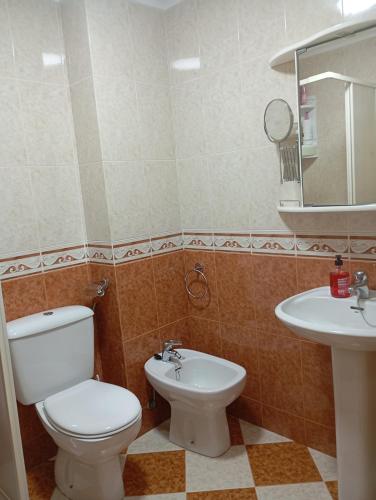 a bathroom with a toilet and a sink at Casa Chus in Foz
