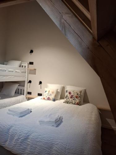 a bedroom with a bed with two trays on it at De Flamberthoeve in Ieper