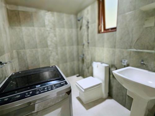 a small bathroom with a sink and a toilet at Ocean Breeze Apartment Colombo in Colombo