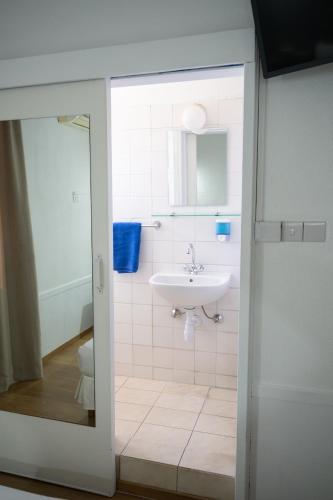 a bathroom with a sink and a toilet at Le Village Hotel in Limassol