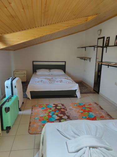 a bedroom with a bed and a rug on the floor at WoodenGate in Fethiye
