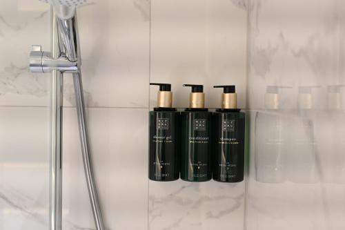 a group of four black bottles sitting on a wall at Clarion Hotel Oslo Airport in Gardermoen