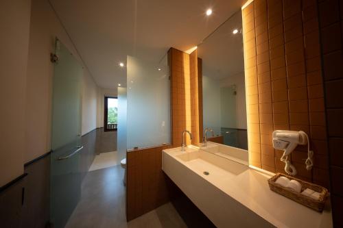 a bathroom with a sink and a mirror at Padang Padang Inn in Uluwatu