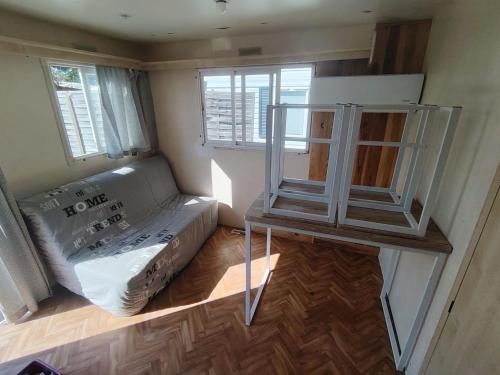 a small room with a couch and a table at Camping Les Embruns N2 in Le Grau-dʼAgde