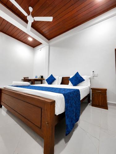 a bedroom with a large bed with a wooden ceiling at Coastal Breeze Talalla in Talalla South