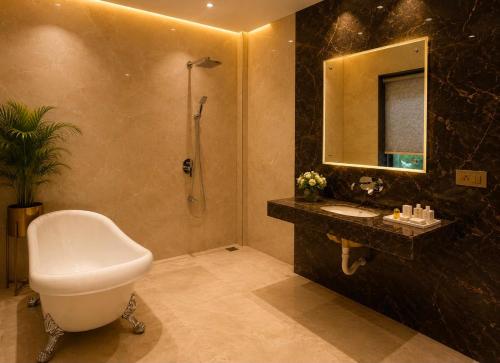 a bathroom with a toilet and a sink and a shower at Emerald Resorts and Hotel in Jāmb