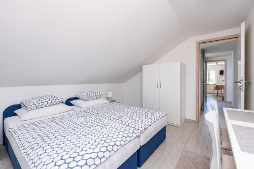 a white bedroom with a blue and white bed at Hanas Dream Places in Zaton