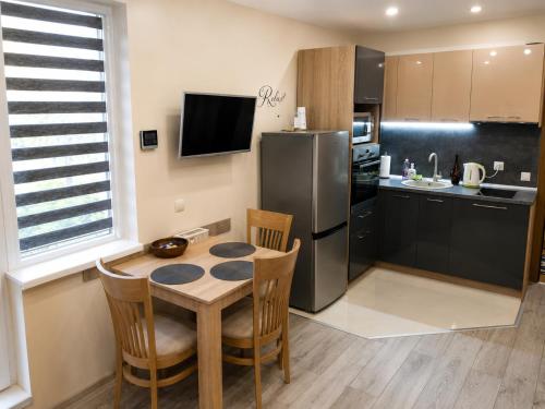a kitchen with a table and a refrigerator at Apartment RELAX, City Centre, Free Wi-Fi, Self Check-In in Ruse