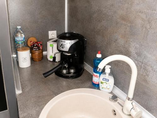 a kitchen counter with a coffee maker and a sink at Apartment RELAX, City Centre, Free Wi-Fi, Self Check-In in Ruse