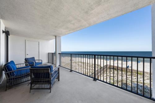 a balcony with chairs and a view of the beach at Wind Drift South East 404 in Orange Beach