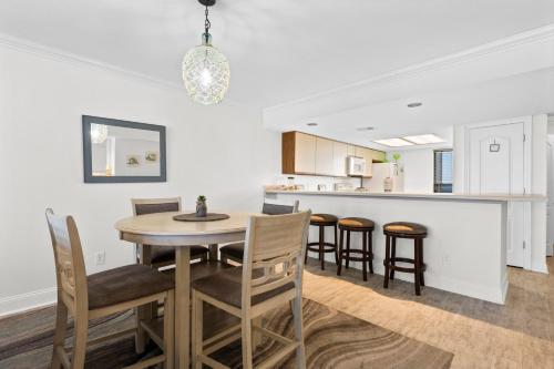 a kitchen and dining room with a table and chairs at Wind Drift South East 404 in Orange Beach