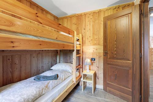 a bedroom with two bunk beds in a log cabin at Punta Ceresole 4061 Maison Gerard in Cogne