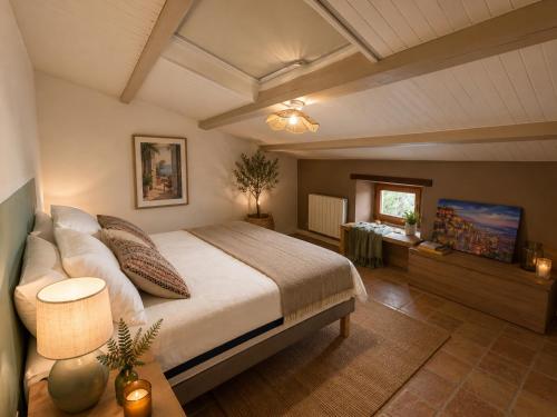 a bedroom with a large bed and a table at Entre Ciels et Lettres in Grignan