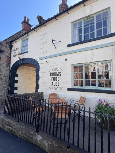 a building with a sign on the side of it at George & Dragon Hotel in Kirkbymoorside