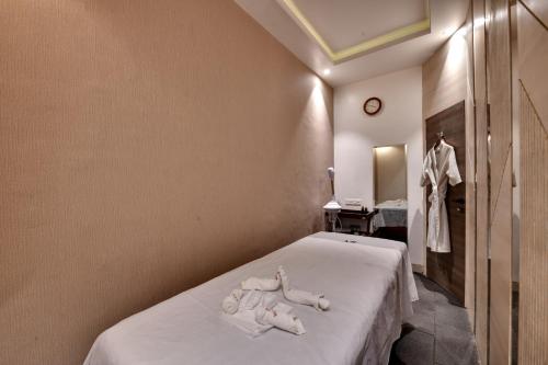 a bedroom with a bed with two towels on it at Hotel Suba Palace Near Gateway of India in Mumbai