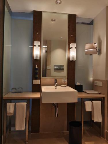 a bathroom with a sink and a mirror at Four Points by Sheraton Bengaluru Whitefield in Bangalore