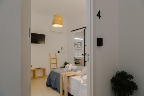 a room with a bed and a room with a mirror at Niña Mala in Valencia