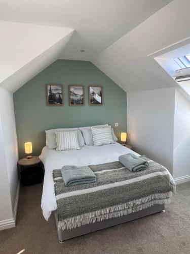 a bedroom with a large bed in a attic at The Ferry Loft Montrose in Montrose