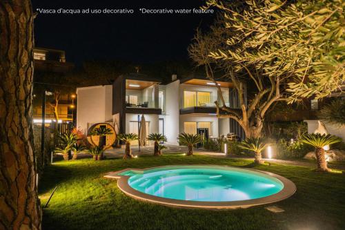 a swimming pool in the yard of a house at night at Luxury B&B La Riserva Dannunziana in Pescara