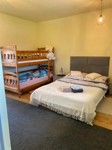 a bedroom with a bed and two bunk beds at Texaco in Kazimierz Dolny