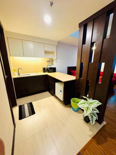 a kitchen with a sink and a counter top at EasyStay Studio Apartment KBCP in Kota Bharu