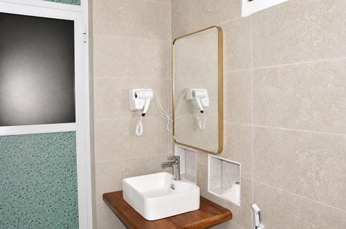 a bathroom with a sink and a mirror at The lagoons resort Zanzibar in Nungwi