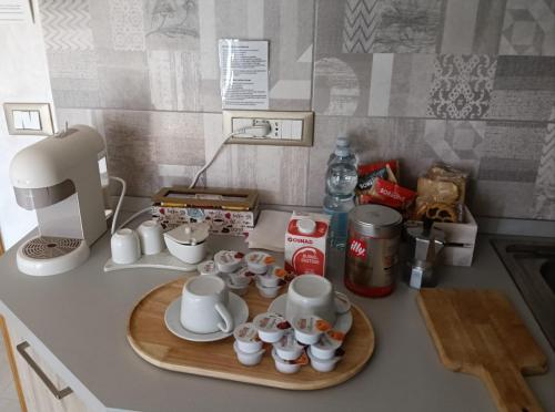 a kitchen counter with a tray of cups and a coffee maker at La Mansarda in San Cesareo