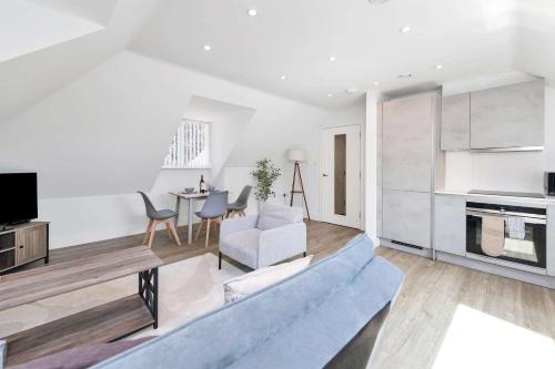a living room with a couch and a table at Addenbrookes Apartment in Trumpington
