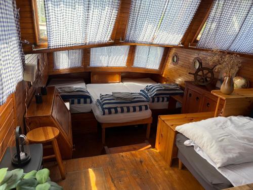 a small room with two beds and a table at Prague River Houseboats - Private Bay in Prague