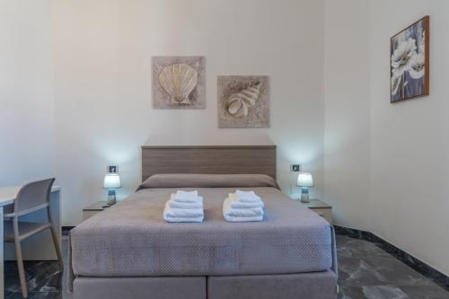 a bedroom with a bed with towels on it at dream house in Olbia