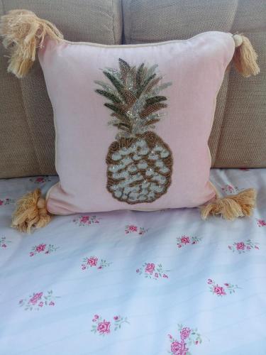 a pineapple pillow is sitting on a bed at Arizona Caravan in Camber