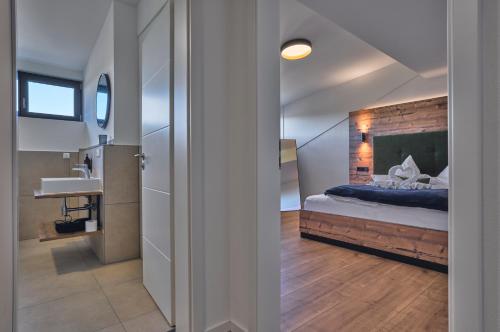a bedroom with a bed and a sink in a room at Annies Bergwelt Haus Waldherz in Bodenmais