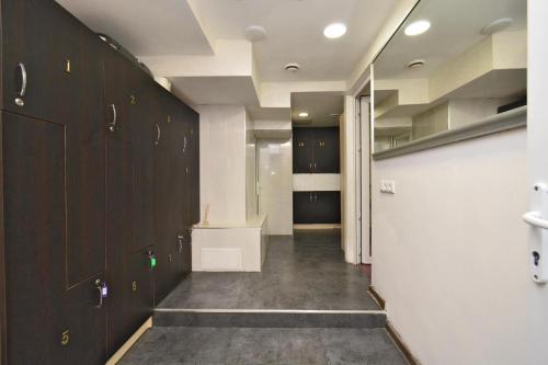 a hallway with dark wood cabinets and a hallway with a corridorngthngthngthngth at Old Yerevan Guesthouses in Yerevan