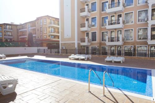 a large swimming pool in front of a building at Polarstar Beach Resort - Premium Apartments in Sveti Vlas