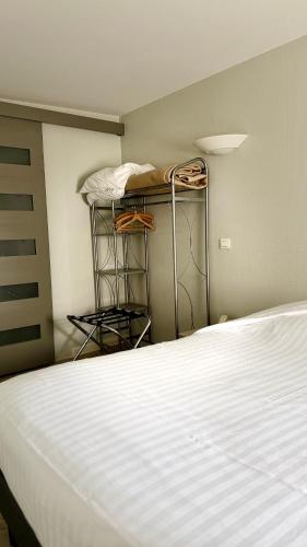 a bedroom with a bed and shelves in a room at Hôtel Restaurant de la Place in Saint-Jean-dʼAngély