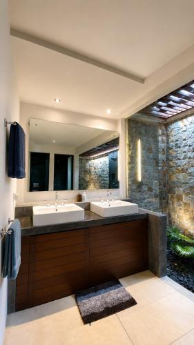a bathroom with two sinks and a large mirror at Villa Layar with Private Pool and Ocean View in Lajor