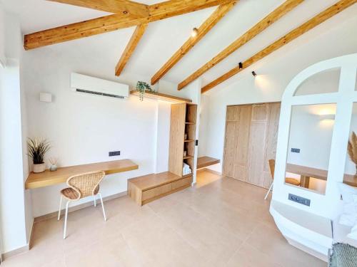 a room with a desk and chair in a room with wooden ceilings at Panorama Inn in Lithakia