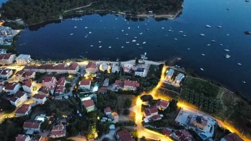 an aerial view of a town by the water at night at Apartments Vukalovic in Medulin