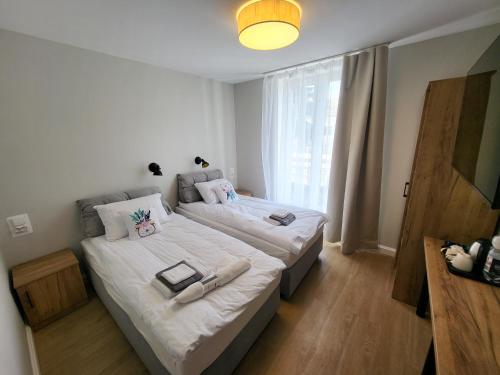 a bedroom with two beds and a window at PannaiLew in Ciechocinek