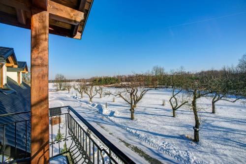 a winter view from a balcony of a house with trees at Noclegi Dwór Szlachecki Biedaczów in Biedaczów