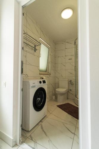 a washing machine in a bathroom with a toilet at Starfish Apartments in Sutivan