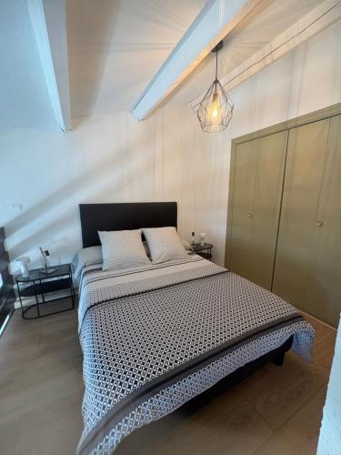 a bedroom with a large bed in a room at Le recantou duplex in Marseillan