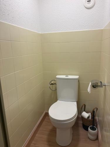 a bathroom with a white toilet in a room at Le recantou duplex in Marseillan