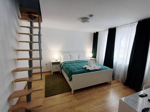 a bedroom with a bed and a staircase in it at Pensiunea CARLA in Sărata-Monteoru